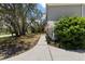 Inviting front walkway leading to a home with an American flag, lush greenery, and mature trees at 11207 Donneymoor Dr, Riverview, FL 33569