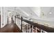 Second-floor hallway with wood floors overlooks living area with plenty of natural light at 11207 Donneymoor Dr, Riverview, FL 33569