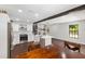 Open-concept kitchen boasts white cabinets, stainless appliances, marble counters, and seamless flow into the living space at 11207 Donneymoor Dr, Riverview, FL 33569