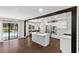 Bright and open kitchen with stainless steel appliances and island, connected to the pool at 11207 Donneymoor Dr, Riverview, FL 33569