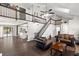 Spacious living room featuring wood floors, high ceilings and staircase to loft area at 11207 Donneymoor Dr, Riverview, FL 33569