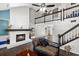 Bright living room with fireplace, white brick accent wall, and views of the upstairs loft at 11207 Donneymoor Dr, Riverview, FL 33569