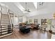 Open-concept living room with high ceilings, a staircase, and an abundance of natural light from multiple windows at 11207 Donneymoor Dr, Riverview, FL 33569