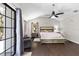 Bright main bedroom with vaulted ceiling offers a ceiling fan and a view to the beautiful backyard through a large window at 11207 Donneymoor Dr, Riverview, FL 33569
