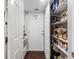 Walk-in pantry with door to laundry room boasts plenty of storage with shelving filled with groceries and essentials at 11207 Donneymoor Dr, Riverview, FL 33569