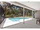 Screened-in pool area offers relaxation with a covered patio, a clear view of the RV, and mature trees at 11207 Donneymoor Dr, Riverview, FL 33569