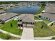 Beautiful aerial view of a two-story home with a pond view and lush green lawn at 11924 Brighton Knoll Loop, Riverview, FL 33579