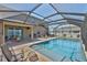 Expansive backyard featuring a shimmering pool, lanai, and outdoor grill, ideal for entertaining at 11924 Brighton Knoll Loop, Riverview, FL 33579