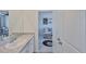 Bathroom with granite counters, white cabinets and doorway to a living room area at 11924 Brighton Knoll Loop, Riverview, FL 33579