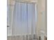Bathroom features a white shower curtain, tile shower, and white toilet at 11924 Brighton Knoll Loop, Riverview, FL 33579