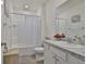 Bright bathroom with granite counters, a tub with shower and modern fixtures at 11924 Brighton Knoll Loop, Riverview, FL 33579
