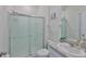 Bathroom with glass-enclosed shower, a white vanity and sink, and decorative accents at 11924 Brighton Knoll Loop, Riverview, FL 33579