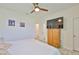 Cozy bedroom featuring a ceiling fan, wood-look floors, and built-in storage cabinet at 11924 Brighton Knoll Loop, Riverview, FL 33579