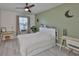An updated bedroom with a ceiling fan, a green accent wall, and a window at 11924 Brighton Knoll Loop, Riverview, FL 33579