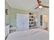 An updated bedroom with a ceiling fan, records on the wall and a walk-in closet at 11924 Brighton Knoll Loop, Riverview, FL 33579