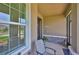 Charming front porch with a chair, plants and brick accents, creating an inviting entrance at 11924 Brighton Knoll Loop, Riverview, FL 33579