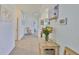 Inviting hallway with a decorative table, fresh flowers, and views of the home's interior at 11924 Brighton Knoll Loop, Riverview, FL 33579