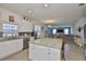 Modern kitchen features stainless steel appliances, granite countertops, and an island with barstool seating at 11924 Brighton Knoll Loop, Riverview, FL 33579