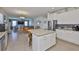 Open kitchen featuring stainless steel appliances, granite countertops, a central island, and an adjacent dining and living area at 11924 Brighton Knoll Loop, Riverview, FL 33579