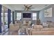Relaxing living room featuring comfortable seating, a ceiling fan, and sliding glass doors at 11924 Brighton Knoll Loop, Riverview, FL 33579
