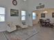 Stylish living room with tall ceilings and elegant furnishings flowing into the dining area at 11924 Brighton Knoll Loop, Riverview, FL 33579