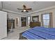 A spacious main bedroom with an ensuite bathroom, ceiling fan, wood-look floors and exercise equipment at 11924 Brighton Knoll Loop, Riverview, FL 33579