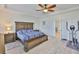 Relaxing main bedroom boasts a ceiling fan, a king-sized bed, and an exercise machine at 11924 Brighton Knoll Loop, Riverview, FL 33579