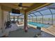 Covered patio with outdoor kitchen and dining leading to the sparkling pool with scenic view at 11924 Brighton Knoll Loop, Riverview, FL 33579