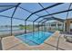 Screened in-ground pool with a view of a lake at 11924 Brighton Knoll Loop, Riverview, FL 33579
