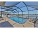 Refreshing pool enclosed within a screened lanai, overlooking a serene lake at 11924 Brighton Knoll Loop, Riverview, FL 33579
