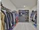 Organized walk-in closet with custom shelving, rods, and ample storage space at 11924 Brighton Knoll Loop, Riverview, FL 33579