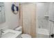 Well-lit bathroom with a white marble tiled shower, modern fixtures, and nautical decor at 12106 Clarendon Ave, Port Charlotte, FL 33981