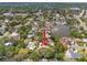 An aerial view highlights the property with its waterfront location, lush greenery, and community atmosphere at 1240 Harbor Lake Dr, Largo, FL 33770