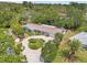 Scenic aerial shot of home featuring lush landscaping and circular driveway at 1240 Harbor Lake Dr, Largo, FL 33770