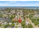 An aerial view showcases the property's waterfront location with a canal and lush landscaping, in a desirable neighborhood at 1240 Harbor Lake Dr, Largo, FL 33770