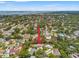 An aerial view of the property features a waterfront canal, lush landscaping, and neighborhood amenities in the surrounding area at 1240 Harbor Lake Dr, Largo, FL 33770