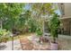A well-maintained backyard features a blend of decorative rock landscaping and lush foliage, offering a tranquil outdoor setting at 1240 Harbor Lake Dr, Largo, FL 33770