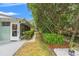 Backyard view, complete with manicured landscaping and screened in patio at 1240 Harbor Lake Dr, Largo, FL 33770