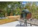 Backyard featuring an outdoor cooking area, wooden deck and beautiful landscaping at 1240 Harbor Lake Dr, Largo, FL 33770