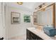 Well-lit bathroom with custom vanity, gold hardware, and decorative mirror at 1240 Harbor Lake Dr, Largo, FL 33770