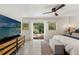 Sun-filled primary bedroom with outdoor access, ceiling fan, and decorative furnishings at 1240 Harbor Lake Dr, Largo, FL 33770