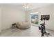 Bright bedroom featuring a window view, neutral paint, tile floors, and a stationary bike at 1240 Harbor Lake Dr, Largo, FL 33770