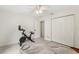 Neutral bedroom with tile floors, closet, ceiling fan, and a stationary bike at 1240 Harbor Lake Dr, Largo, FL 33770