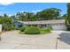 Charming single-story home featuring an attached garage and a circular driveway at 1240 Harbor Lake Dr, Largo, FL 33770