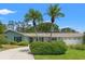 Charming single-story home with manicured landscaping and an attached garage at 1240 Harbor Lake Dr, Largo, FL 33770