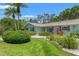 Beautiful front yard with mature trees, shrubs, and well-maintained lawn at 1240 Harbor Lake Dr, Largo, FL 33770