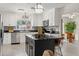 Well-lit kitchen featuring white cabinets, granite counters and stainless appliances at 1240 Harbor Lake Dr, Largo, FL 33770
