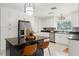 Modern kitchen with white cabinets, stainless steel appliances, and black granite countertops at 1240 Harbor Lake Dr, Largo, FL 33770