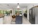 Open kitchen with stone countertops, stainless appliances, breakfast bar and dining area at 1240 Harbor Lake Dr, Largo, FL 33770