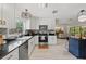 Modern kitchen with sleek stainless steel appliances, white cabinets, and granite counters at 1240 Harbor Lake Dr, Largo, FL 33770